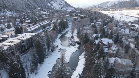 Avon, Colorado USA. Aerial View of Buildings by Eagle River in Snowy Winter Landscape, Drone Shot