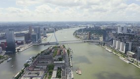 Inscription on video. Rotterdam, Netherlands. Norderayland Island ( North Island ) and Erasmus Bridge ( Erasmusbrug ) over the Nieuwe Maas River. Lightning strikes the letters, Aerial View, Point of