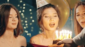 Young woman blowing out fire on candles and making wish at party or celebration. Close-up portrait of smiling asian girl and friends making surprise and taking out birthday cake with candles. - Powered by Shutterstock - Get 15% off with code: PIKWIZARD15