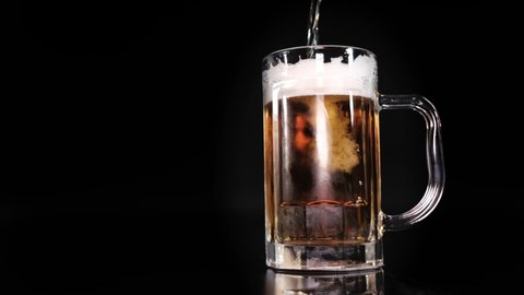 Beer pouring and overflow from beer mug