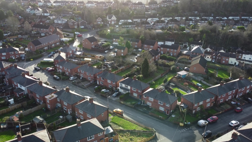 Generic view of a British street of houses with moving car