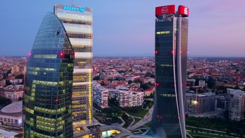 Glass buildings in Europe City Life. Aerial view of the modern architecture of office buildings in the city districts. the drone shoots three towers. Business. Bank. Sky. Italy, Milan, April 2022