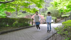 Asian children running in nature