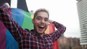 Happy gay man having fun holding rainbow flag symbol of LGBTQ community - Powered by Shutterstock - Get 15% off with code: PIKWIZARD15