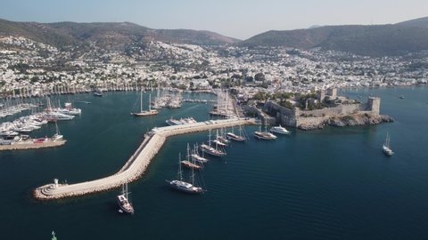 Bodrum, Turkey - October 18, 2021: Awesome aerial view of Bodrum Castle and Bodrum Marina. Drone flying over the sea. The port city is a popular tourist destination in the Turkish Riviera.