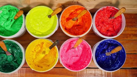 top view of colorful ink in factory tee shirt.Different colors are organized for t-shirt printing.
The color of the ink lays neatly on the wooden floor.
colorful of ink background.