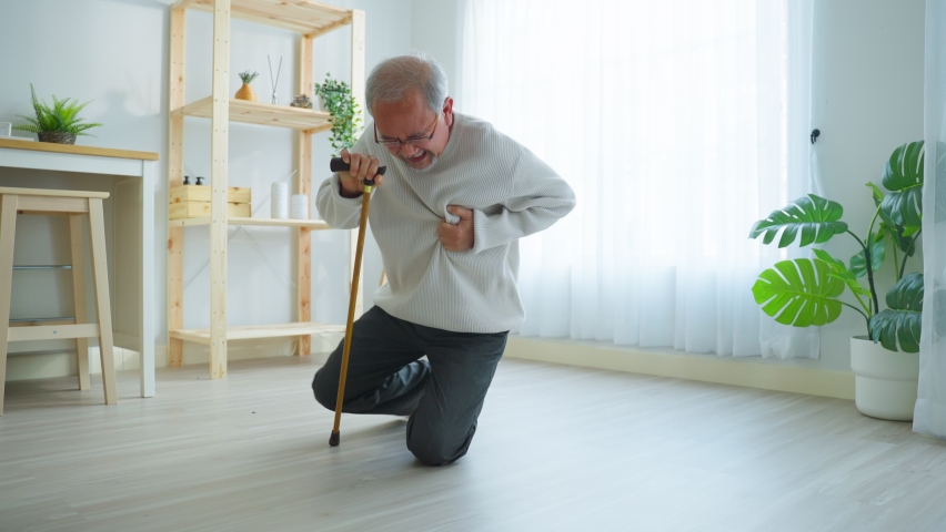 Asian senior older man having chest pain feel suffer from heart attack. Attractive older mature patient has difficulty breath clutching chest from acute pain while walking with walker in living room. | Shutterstock HD Video #1089375623