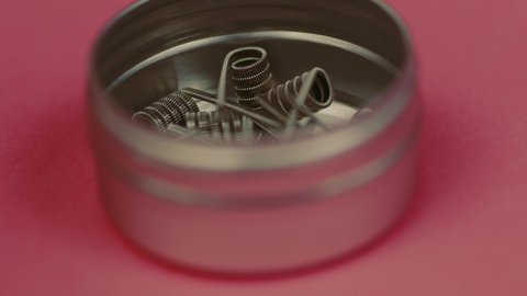 Pre-built coils for vape in box. Iron winding for maintenance of electronic systems. Concept of vaping, modern smoking. Close up.