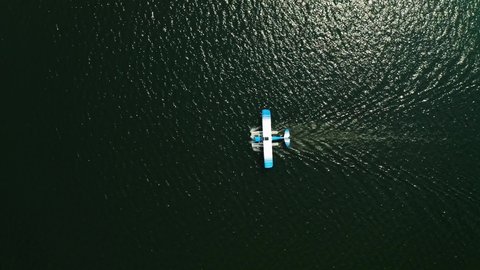 Aerial top down, seaplane floating on ocean lake water