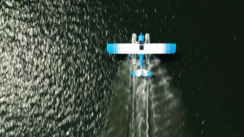 Aerial top down, seaplane taking off from lake water surface. Balsam Lake, Wisconsin