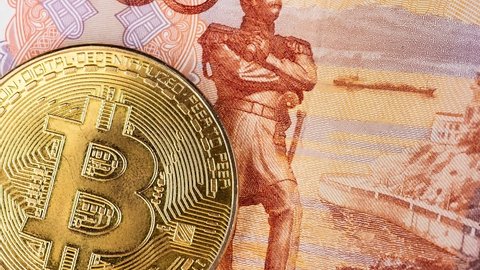 bitcoin cryptocurrency with russian rubles money, five thousand banknotes closeup