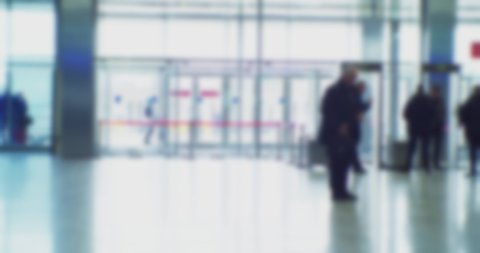 timelapse.modern business life. defocused blurry video. background on the theme of business. blurred silhouettes of unrecognizable people walking in a large hall.