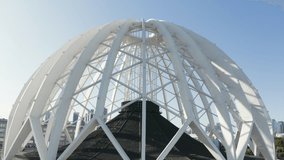 Modern white dome-shaped structure. Stock footage. Top view of beautiful domed structure in modern city. Beautiful domed structure with white body - Powered by Shutterstock - Get 15% off with code: PIKWIZARD15