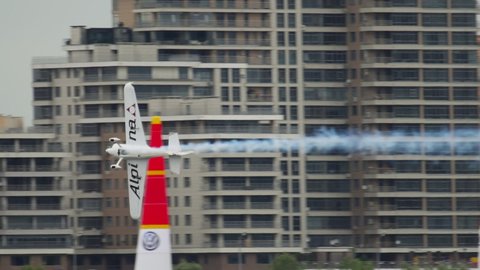 KAZAN, RUSSIAN FEDERATION, JUNE 14, 2019: Slow motion long shot, sports light-engine aircraft performs extreme spectacular stunts in the air at the Red Bull Air air show in Kazan