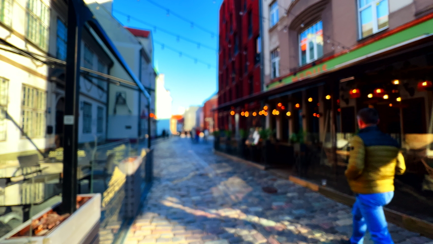 People walking in old streets of amazing and beautiful medieval city of Riga, Latvia
