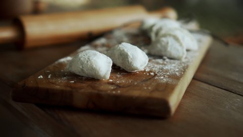 Traditional rustic Russian fresh handmade dumplings lying on the wooden table on the cutting board