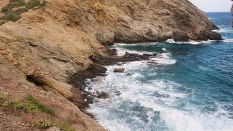 Sea water wash around stone, shallow rocky bottom near coast