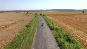 A motorcyclist rides on the highway, having fun and enjoying the road. Cinematic drone tracking shot. Footage from a bird's eye view. Location Ukraine, Europe. Filmed UHD 4k video. Beauty earth.