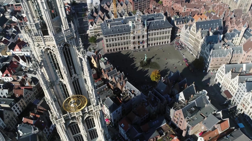 Aerial view of Antwerp Great Market Square the City Hall Guildhouses and the tower of Cathedral of Our Lady in Dutch Onze-Lieve-Vrouwekathedraal is a Roman Catholic building gothic style 4k quality Royalty-Free Stock Footage #1089399145