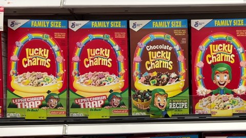 Alameda, CA - April 18, 2022: 4K HD video panning across grocery store shelf with General Mills brand cereals boxes of Lucky Charms. Saint Patrick's themed, chocolate and regular.
