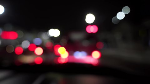 Bokeh of cars and traffic lights at night. Bokeh of small european City Night Traffic. Round colorful bokeh shine from car lights in traffic jam on city street