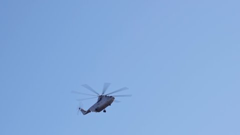 military helicopter in the clear blue sky