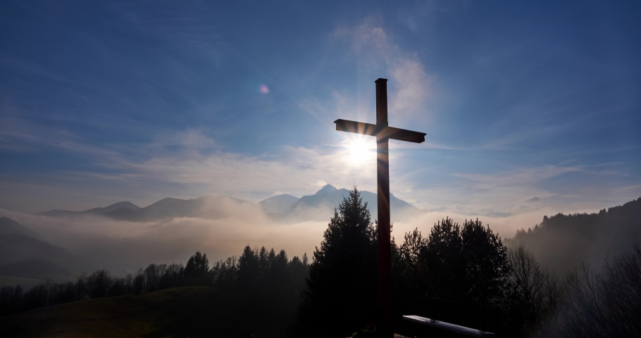 Christian cross in the glow of the sun, mountain landscape above the clouds | Shutterstock HD Video #1089407549