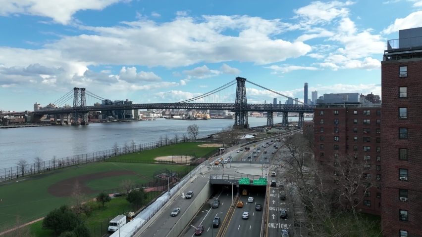 NYC, USA - APR 14, 2022: aerial baseball fields and cars driving on FDR Drive Williamsburg Bridge view in New York City.
