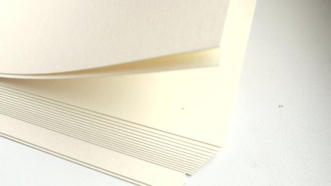 4k video, close-up of a stack of paper, blank white sheets flipping and counting.