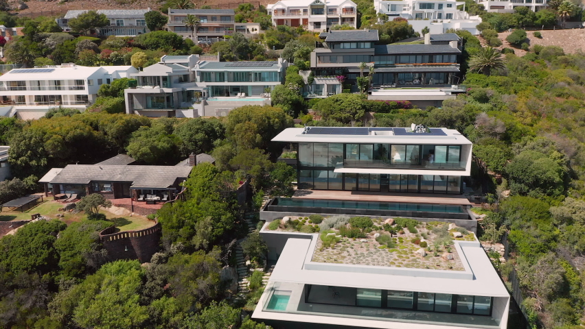 Scenic View Of Luxury Beach Houses At Llandudno Seaside In Cape Town, South Africa. Aerial Shot