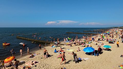 Kaliningrad, Russia, 10, July, 2021:
Many tourists sunbathe on the beach and swim in the sea, many people came on vacation to the beaches of the Russian Baltic