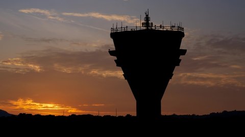 Air Traffic Control Tower in International Passenger Airport, Time Lapse at Sunrise with Colorful Clouds