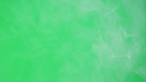 Abstract smoke on green chroma key background. Smoking, steam clouds close-up.