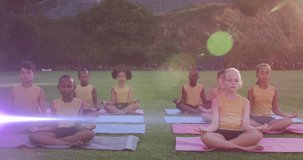 Animation of lights over diverse pupils practicing yoga outdoors. school, education, sport and healthy lifestyle concept digitally generated video.