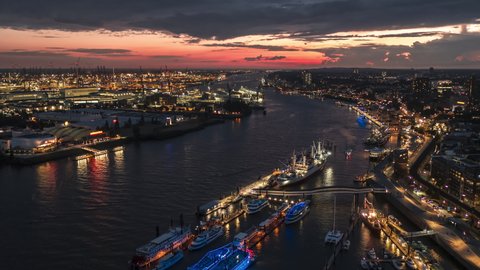 Establishing Aerial View Shot of Hamburg De, Mecklenburg-Western Pomerania, Germany at night evening, view from river, super clear image, amazing sunset in port