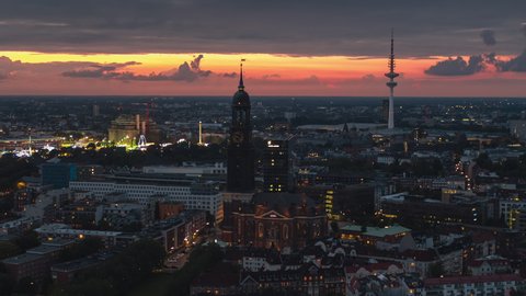 Establishing Aerial View Shot of Hamburg De, Mecklenburg-Western Pomerania, Germany at night evening, view from river, super clear image, beautiful sunset in city