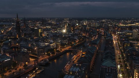 Establishing Aerial View Shot of Hamburg De, Mecklenburg-Western Pomerania, Germany at night evening, view from river, super clear image, incredible view