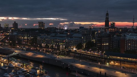 Establishing Aerial View Shot of Hamburg De, Mecklenburg-Western Pomerania, Germany at night evening, view from river, super clear image, incredible sunset in city