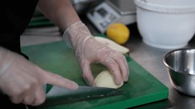 Close-up video of cutting slicing fresh peas. Womans hands cut with knife fresh pear fruits