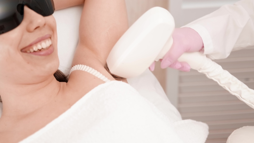 Flash of diode laser hair removal, Beautician removes hair on beautiful female armpits, Hair removal for smooth skin, laser procedure at beauty studio or clinic, Body care epilation treatment. | Shutterstock HD Video #1089437061
