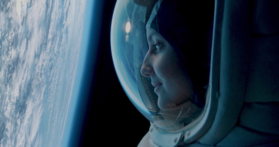 CU Portrait of Caucasian female astronaut during spacewalk on the Earth orbit. Space exploration, Mars mission. Shot with 2x anamorphic lens