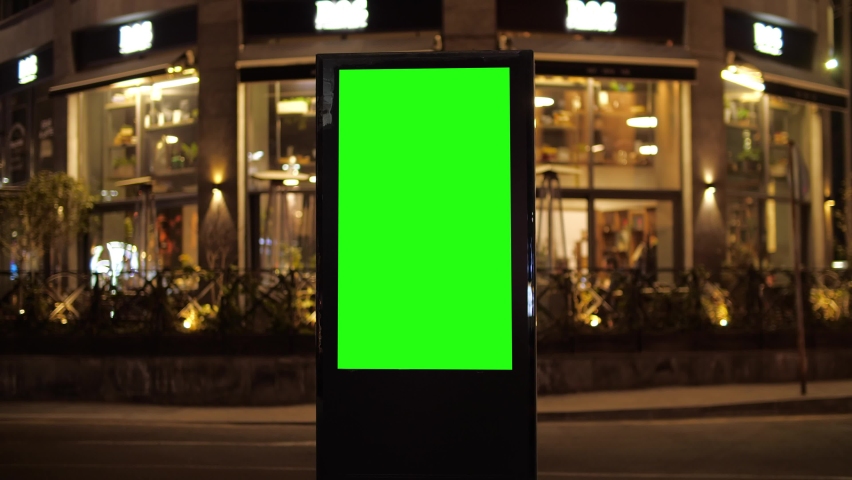 Billboard with a green screen on a background of city traffic in night time Royalty-Free Stock Footage #1089437865