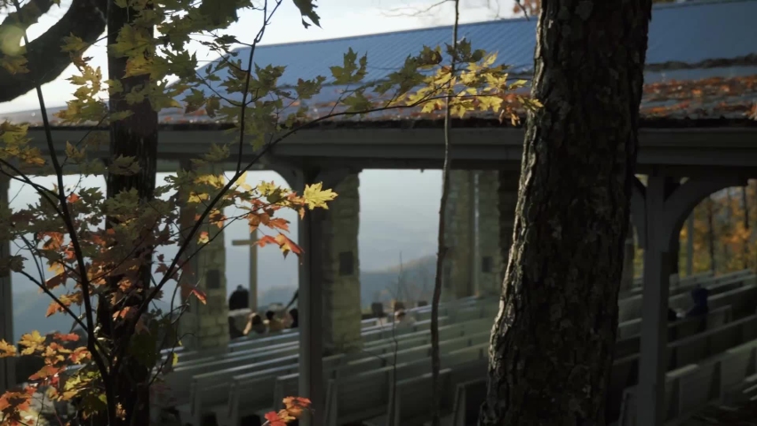 People enjoying the view of pretty place Fred W Symmes Chapel in South Carolina on a sunny autumn day. Slowly Panning shot