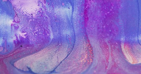 Glitter ink flow. Color fluid mix. Floating shiny liquid. Defocused iridescent purple pink blue shimmering wet paint motion abstract art background shot on RED Cinema camera.