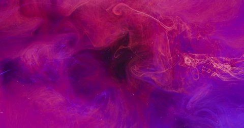 Underwater color explosion. Ink drop. Transition effect. Neon pink blue paint blast on vivid purple mist cloud abstract background shot on Red Cinema camera 6k.