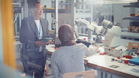 Black Chief Engineer and Promising Computer Scientist in Hijab analysis and Discuss Optimisation of Autonomous Manufacturing Facility that Creates Great Products. High Tech Concept
