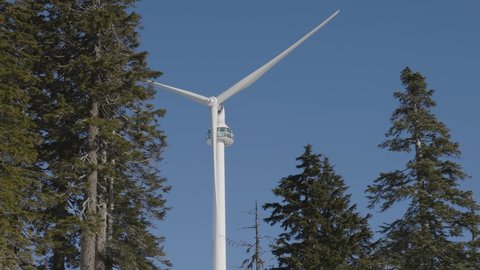 Wind Turbine on top of Grouse Mountain during sunny winter season. Located in North Vancouver, British Columbia, Canada.