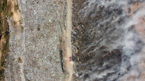 Aerial view fire brigade spray water toward the burning of landfill site