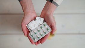 Woman's hands holding and throwing expired pills to the trash bin. - Powered by Shutterstock - Get 15% off with code: PIKWIZARD15