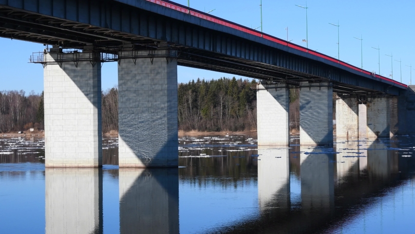 Draw bridge over the river with floating ice floes. Ice melts and drifts on the water in spring.